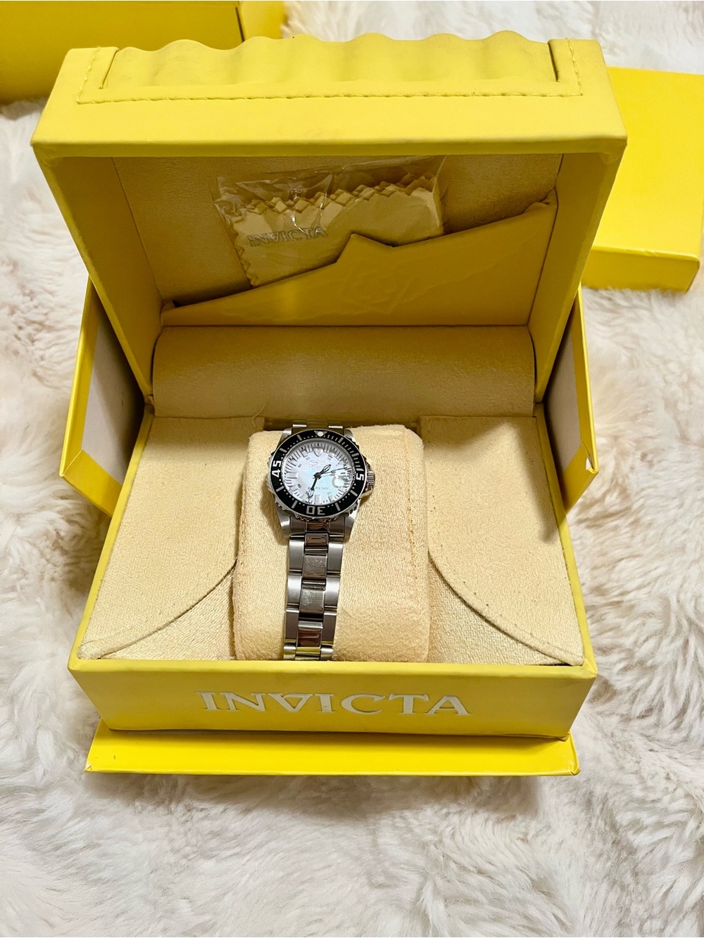 Invicta women’s Silver Stainless Steel Watch with Black Bezel and White Dial